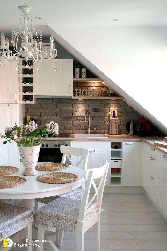 02-an-attic-kitchen-with-the-ceiling-over-the-sink-and-cooker-shelves-that-fit-the-angle.jpg