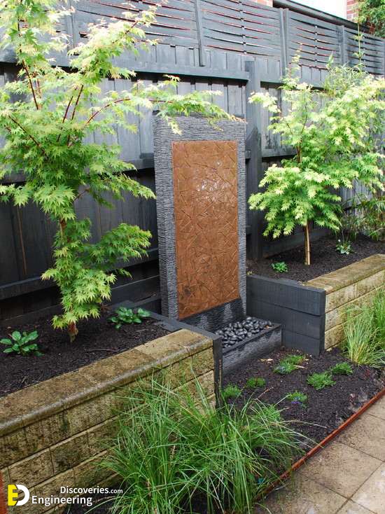 Water-wall-garden-design-ideas-evergreen-plants-trees-stone-wall.jpg