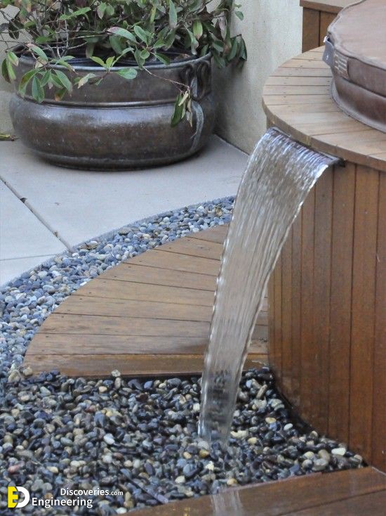 landscape-design-ideas-small-garden-water-fountain-wood-pebbles.jpg