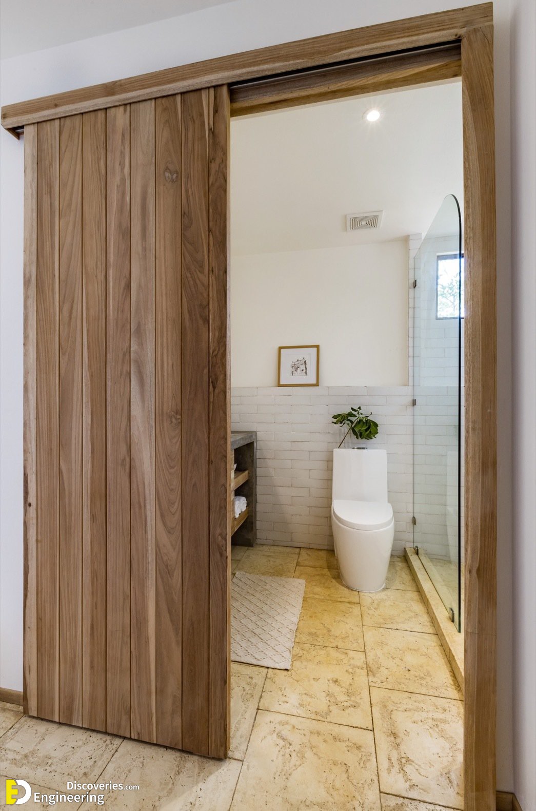 5-to-the-right-of-the-entrance-sliding-tongue-and-groove-laurel-plywood-doors-open-up-to-reveal-the-bathroom.jpg